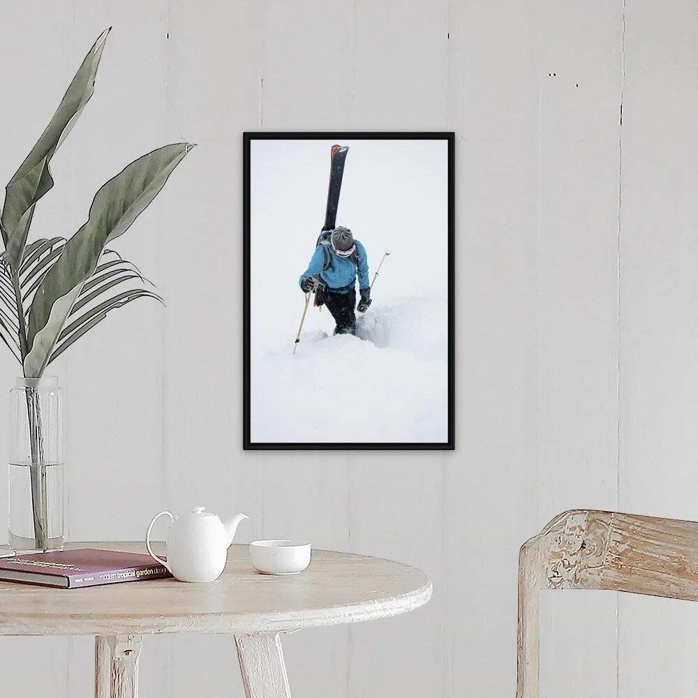 "A young woman packs her skis and kick steps up a section of trail" Black Float Frame Canvas Art