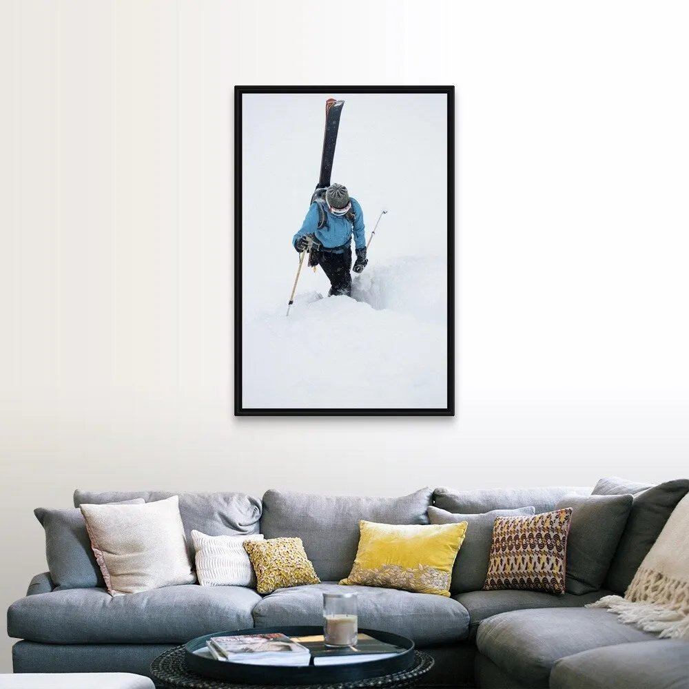 "A young woman packs her skis and kick steps up a section of trail" Black Float Frame Canvas Art