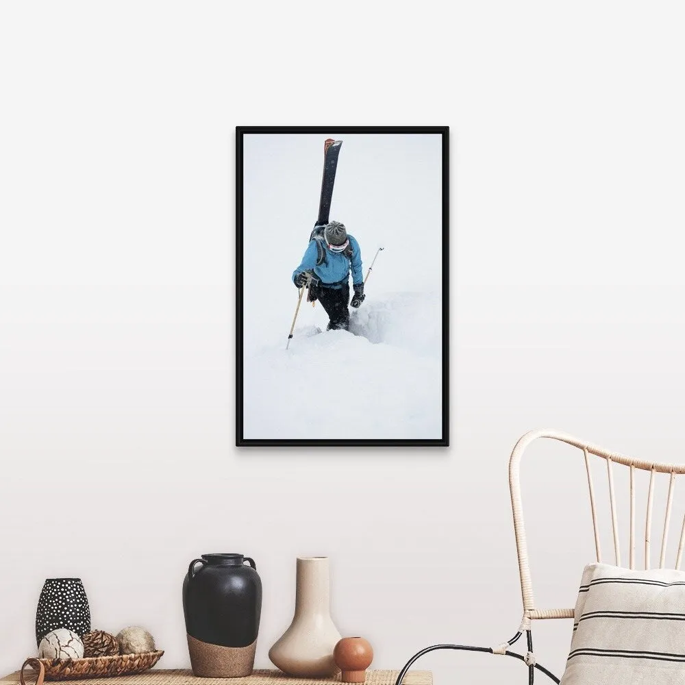 "A young woman packs her skis and kick steps up a section of trail" Black Float Frame Canvas Art